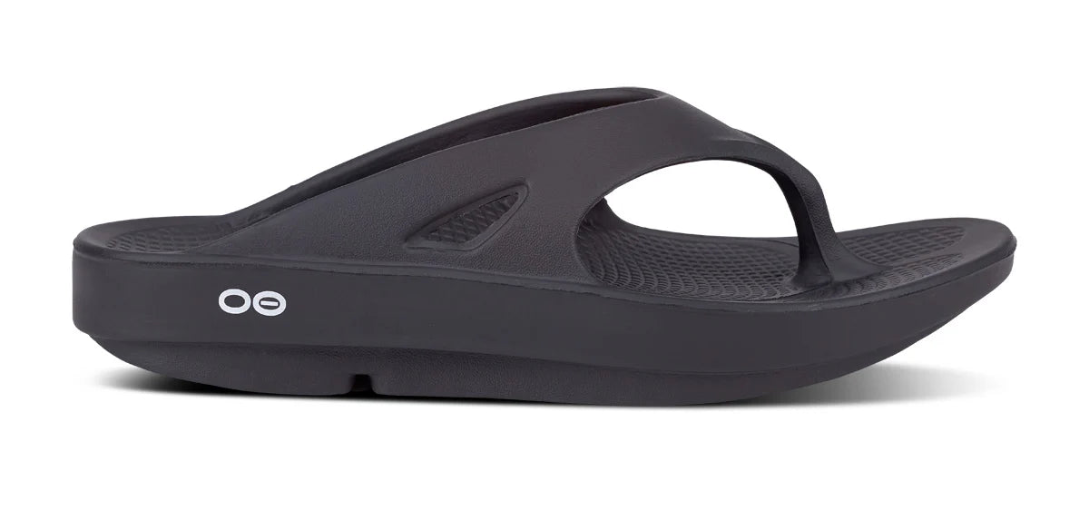 OOFOS OOriginal sandal in black, lateral profile showing the toe post and thong upper