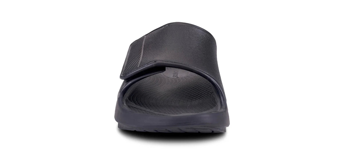 OOFOS Sport Flex slide in matte black, head-on view showing the adjustable strap