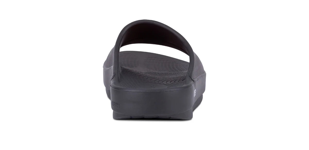 OOFOS OOahh Slide 1100 in black, rear view showing the walled heel cup