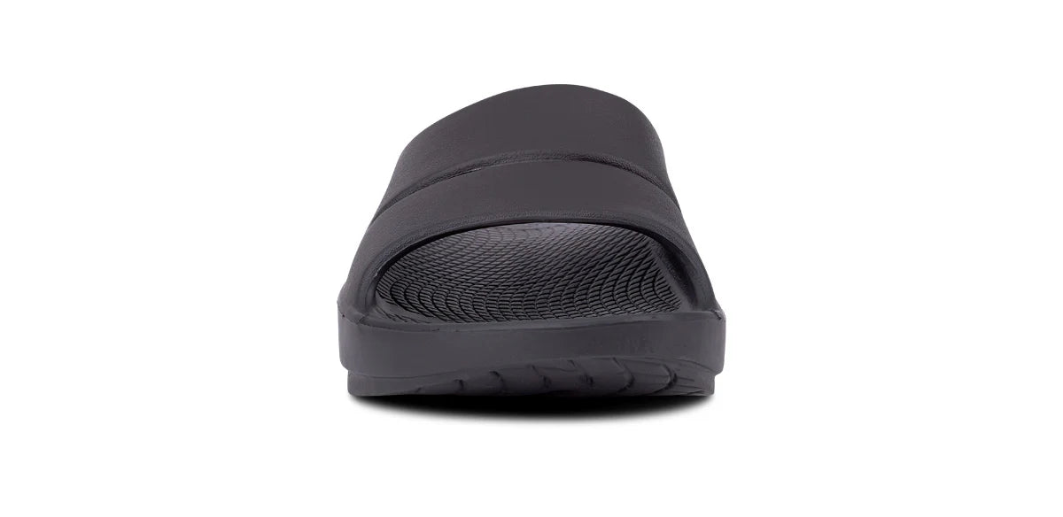 OOFOS OOahh Slide 1100 in black, front view showing forefoot width across the strap